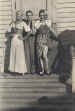 Three prisoners in costume for a theatrical production
