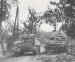 A British Sherman tank passes a knocked-out Panzer
