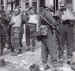 British prisoners, some wounded, being searched by German soldiers