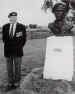 Lieutenant-Colonel Terence Otway in 1998, standing beside a bust of himself at the Merville Battery