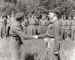 Lieutenant Miller receives his Military Cross from Field Marshal Montgomery on the 1st September 1944