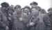 A group of paratroopers are amused to inspect each other's new sleeveless jump suits
